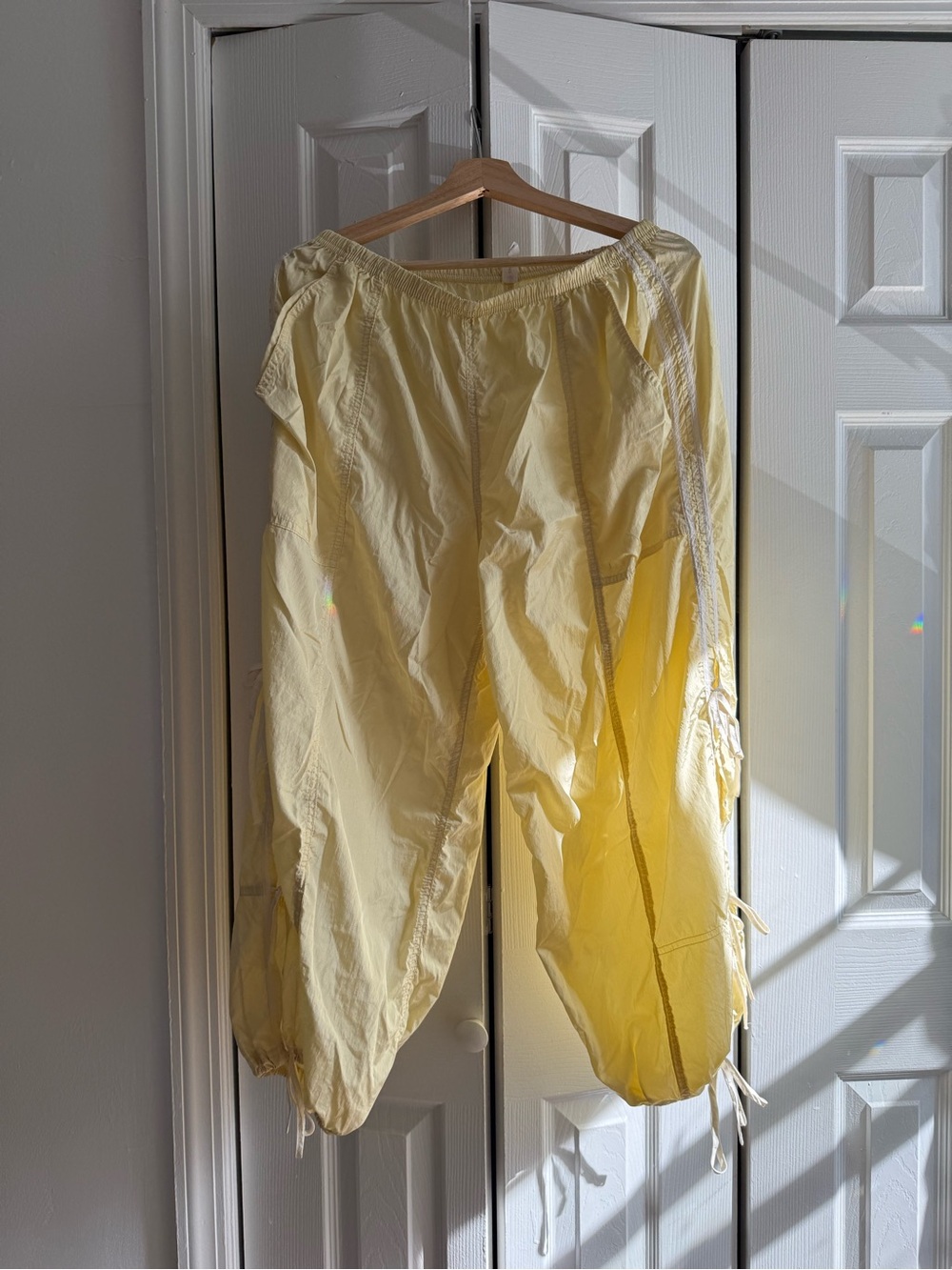 Anthropologie Butter Yellow track pants with bow detail